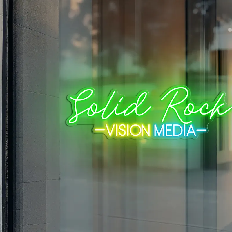 Solid Rock Vision Media custom neon sign in green and yellow